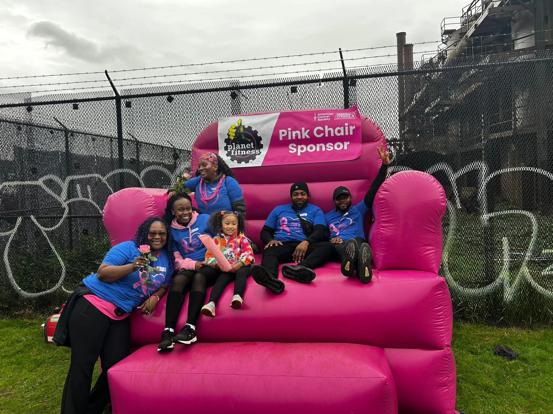 BOH Concepts team and community members on the Pink Chair at a breast cancer awareness event